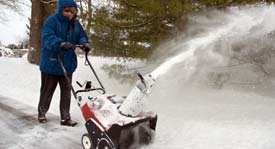 Woman using a snowblower with ergonomic control handle